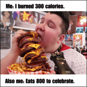 person eating a burger with a proud smile